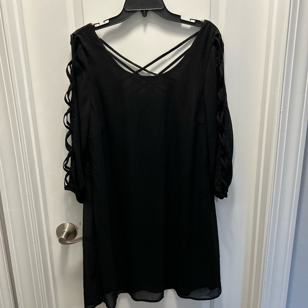 Black knee length dress. Cross cross detail down the sleeves. Size large